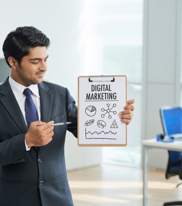 man-suit-standing-office-with-clipboard-pointing-poster-with-words_1098-17121